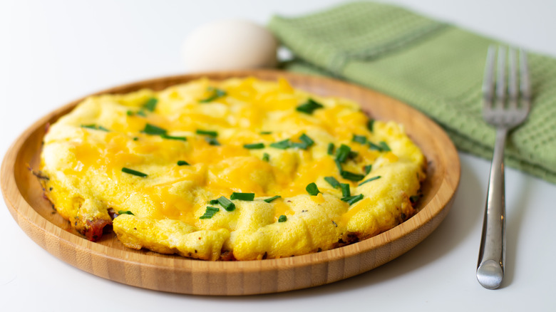 Plate of scrambled eggs with cheese on top