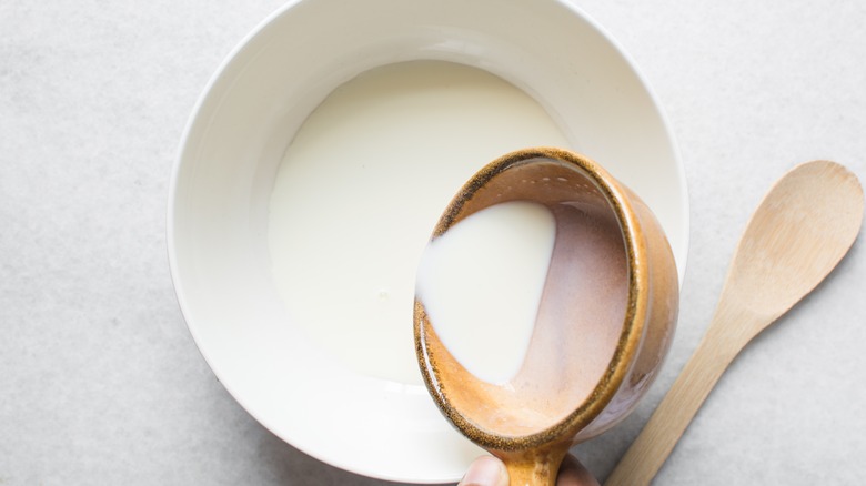 scooping evaporated milk from dish