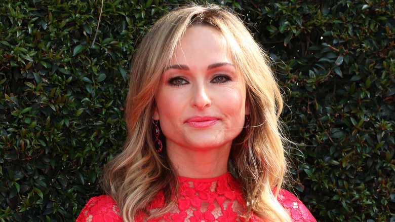 Giada De Laurentiis in a red dress looking serious