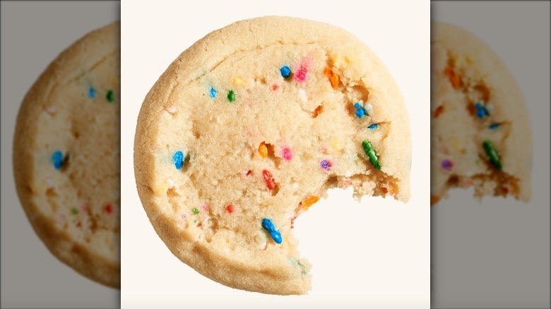 Cookie with sprinkles in it and a bite taken out
