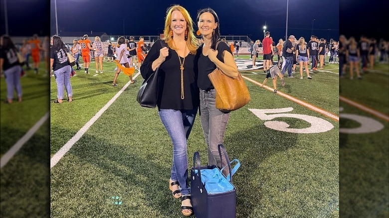 Ree Drummond and sister attending game