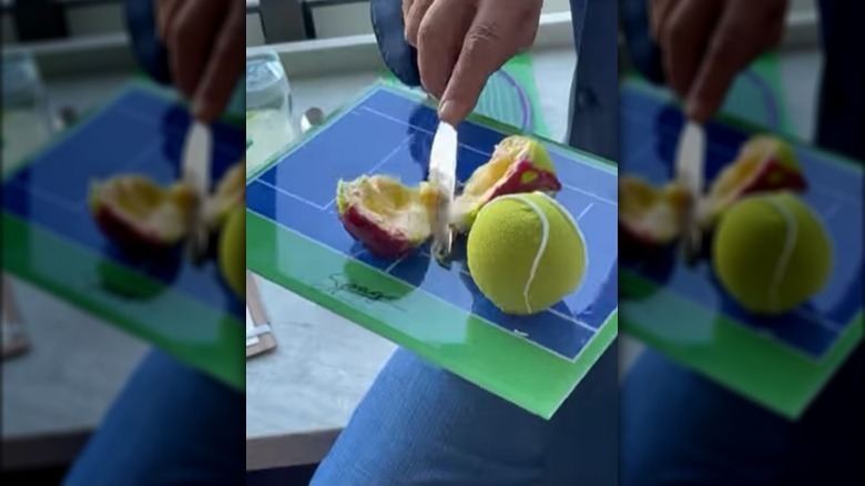 Wolfgang Puck cutting an edible tennis ball in half.