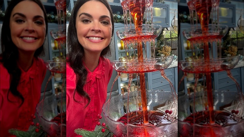 Katie Lee Biegel standing next to a Negroni fountain