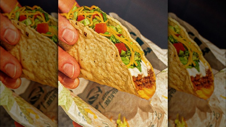 Person holding one of Taco Bell's Crispy Melt Tacos