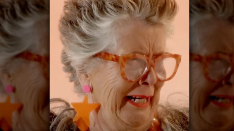 prue leith doing chewbacca impression while wearing chewbacca costume and orange star-shaped earrings