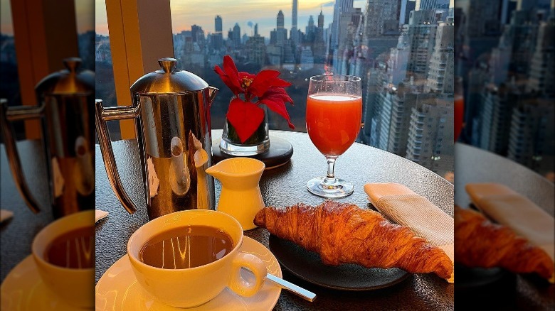 Breakfast spread with juice, coffee, croissant and New York City views