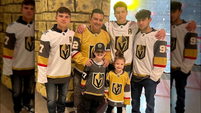 Buddy Valastro posing with his family 