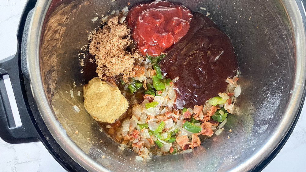 adding barbecue sauce to Instant Pot baked beans