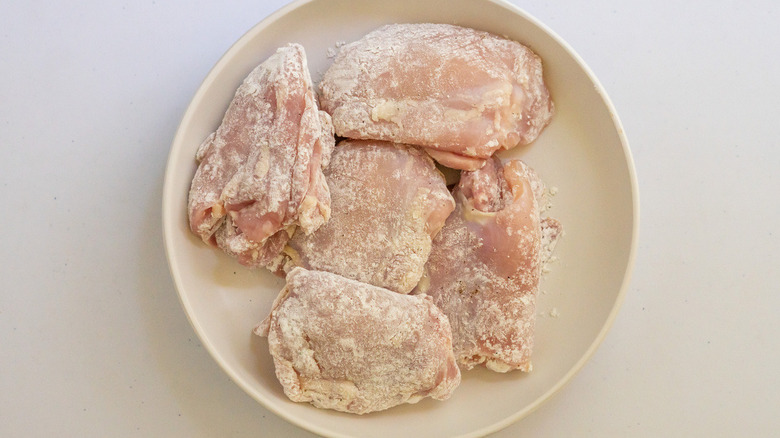 raw chicken dredged in flour and seasoning