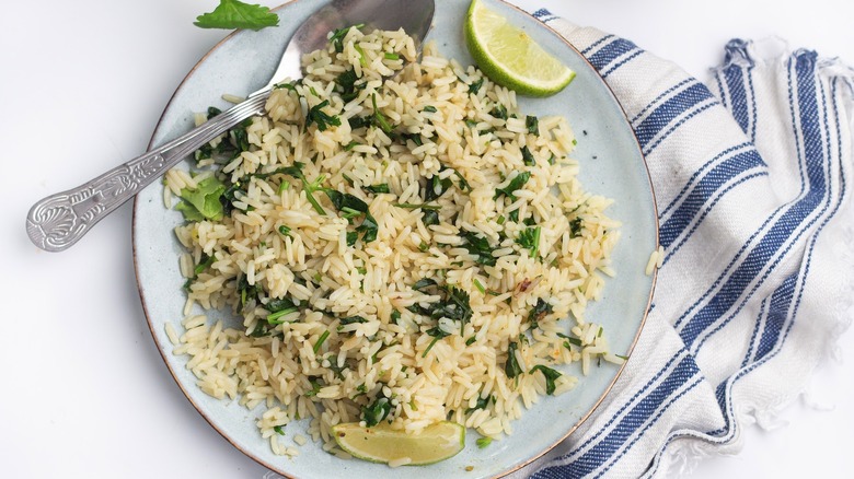 Rice served on a plate with limes