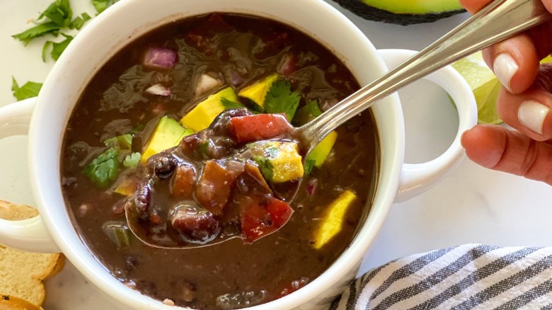Bowl of black bean soup with spoon