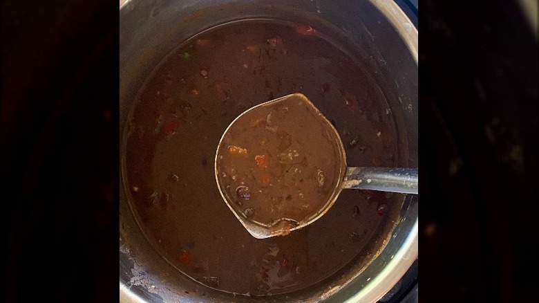 Black bean soup in Instant Pot with metal ladle