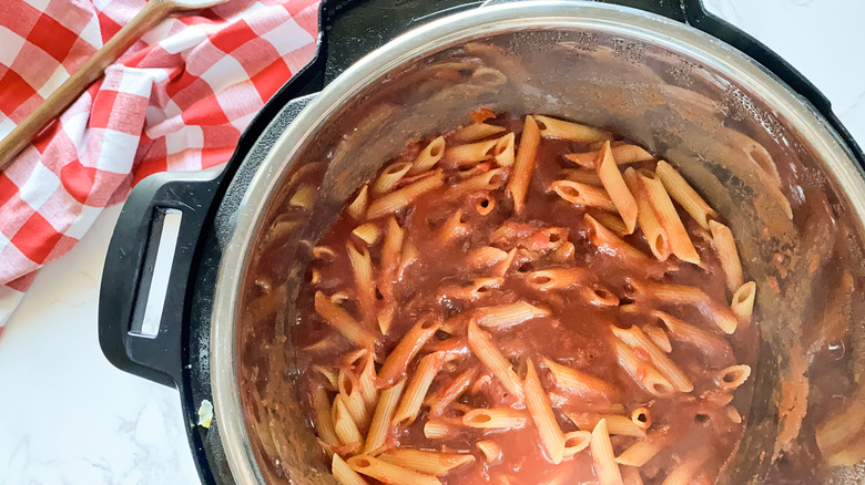 penne and sauce in pot