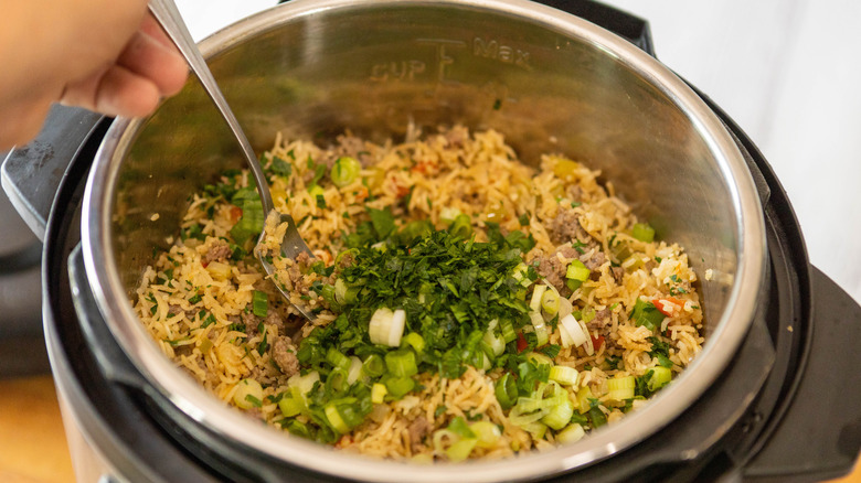 Adding garnish veggies to the meal