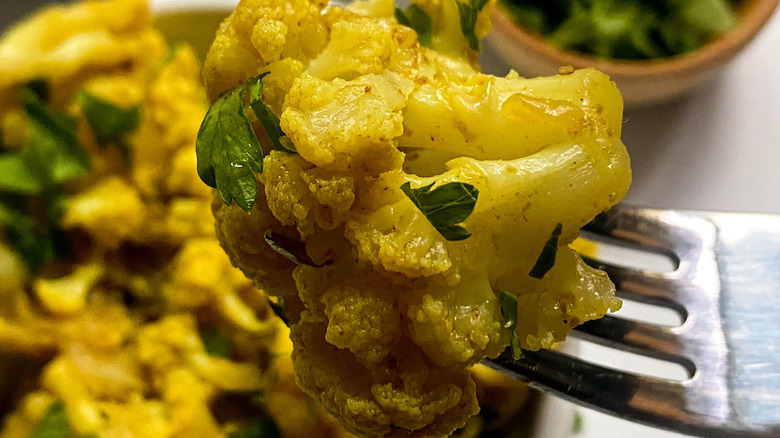 A bite of cauliflower with cilantro