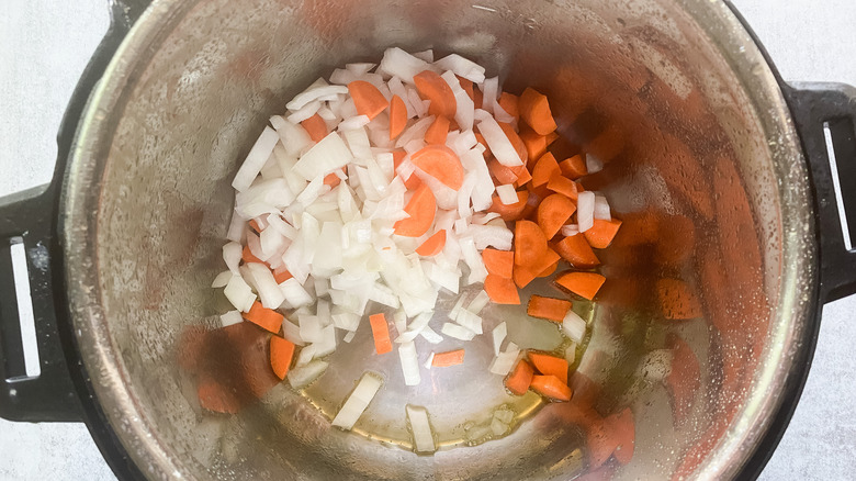 diced carrot and onions in pot