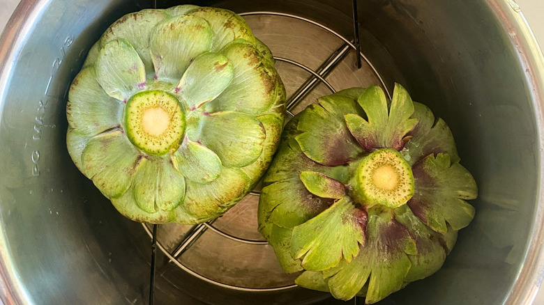 Artichokes over water and wire rack