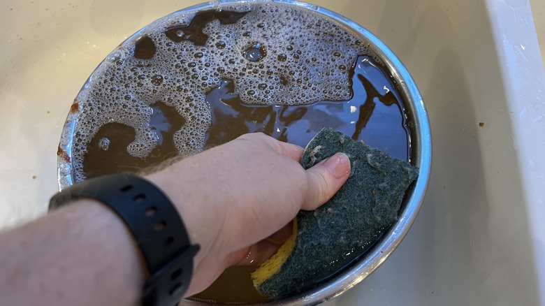 person cleaning instant pot 