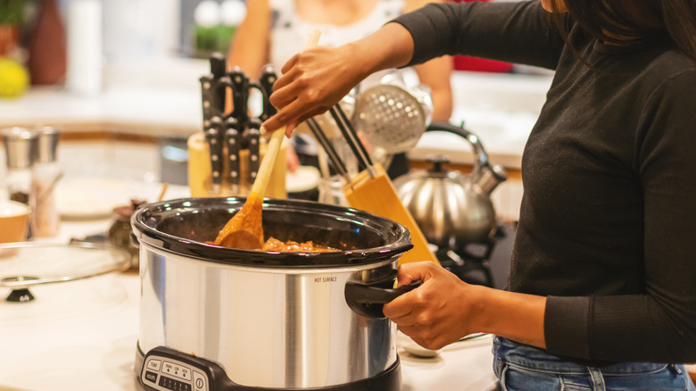 woman cooking with slow cooker