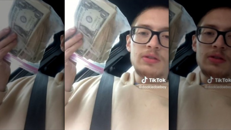 man holding cash in car