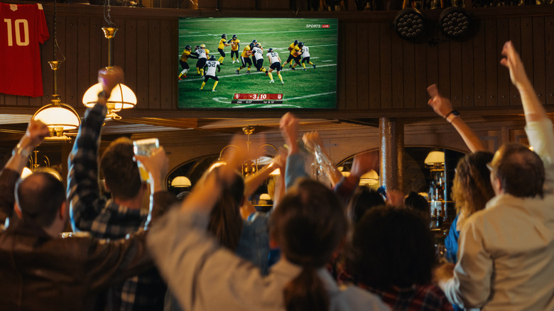 Pub patrons watching soccer game on TV