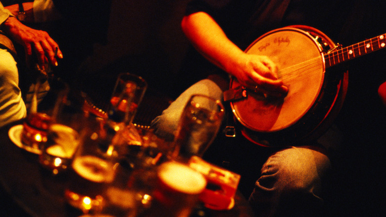 Musician playing banjo in pub