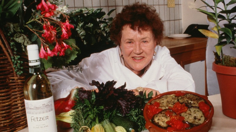 Late chef Julia Child posing with food and wine