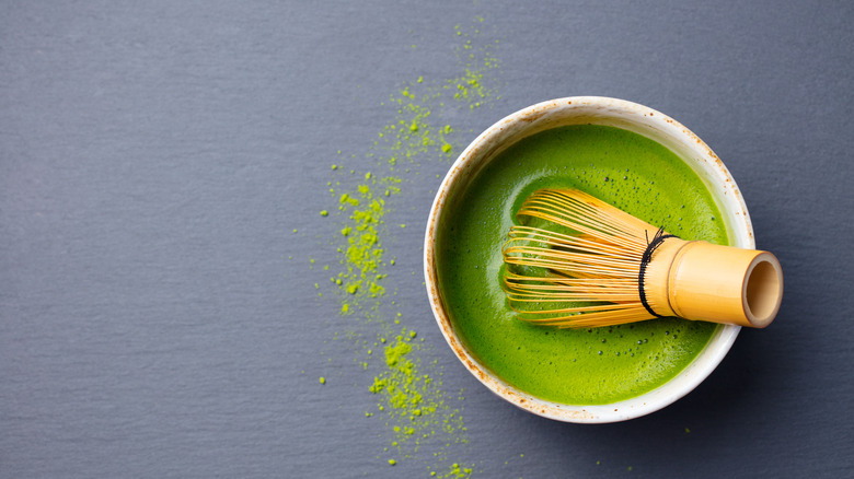 Bamboo whisk in bowl of matcha