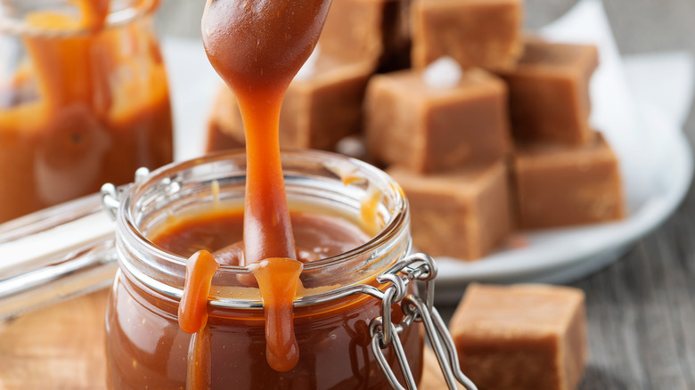 caramel jar with spoon scooping glob of it