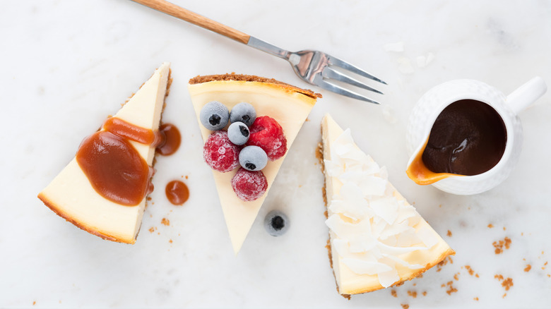 Cheesecake slices with various toppings and fork