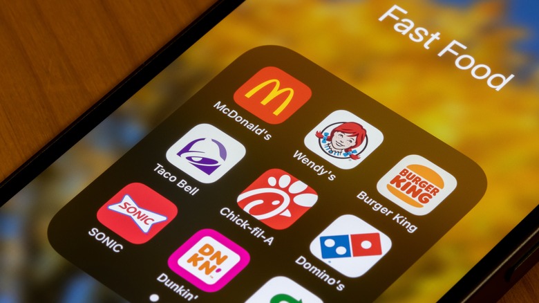 An iPhone screen with a bunch of fast food apps including McDonald's, Chick-fil-A and Wendy's