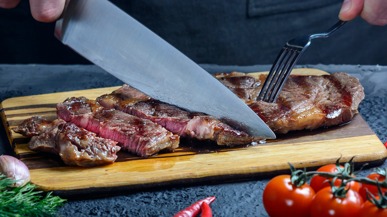 Knife slicing chuck steak