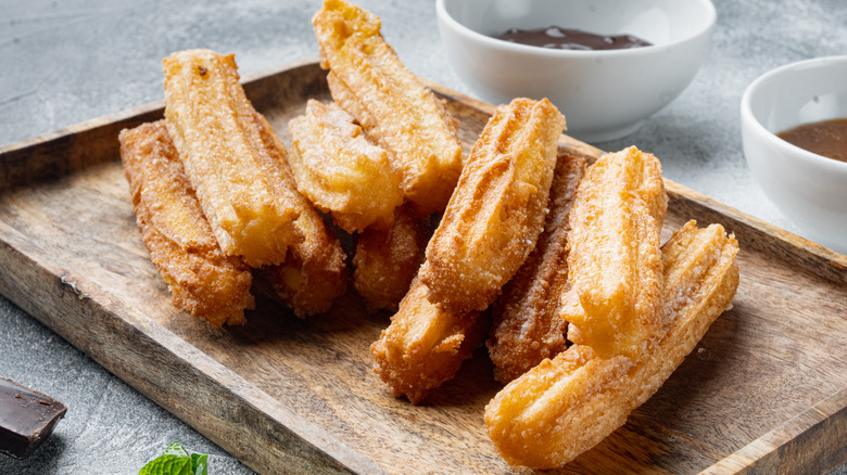 Brown churros on a board