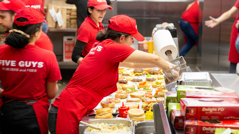 Five Guys workers making burgers