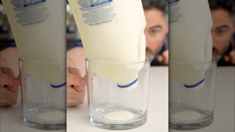 Frozen milk carton upside down in a glass 