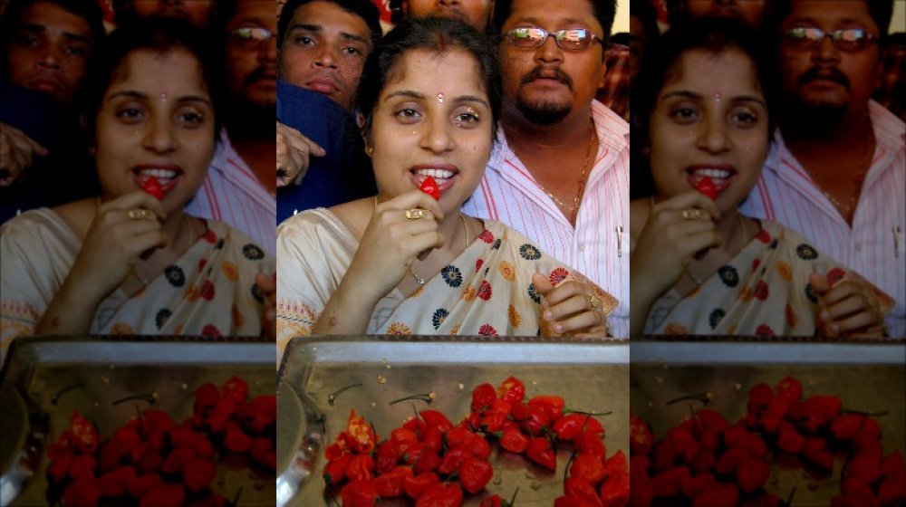 Woman eating ghost pepper