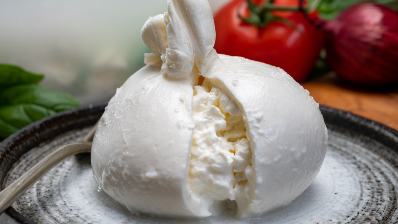 Burrata halved over a plate