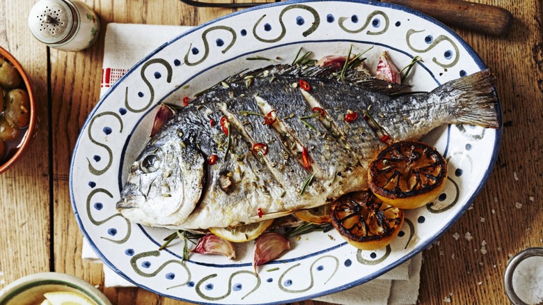 Whole cooked fish on plate