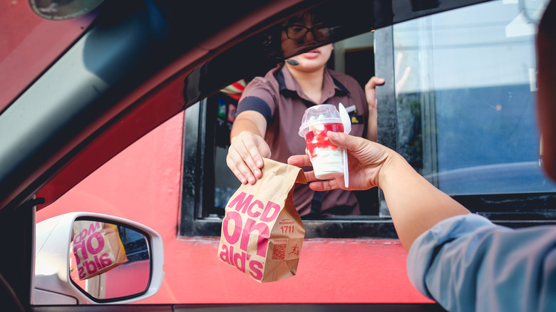 McDonald's customer receiving drive-thru food