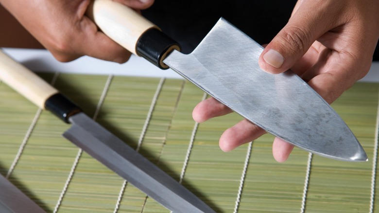 Person holding kitchen knife