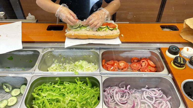 Subway worker making tuna sub 