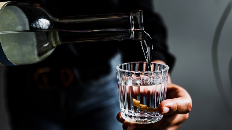 Person pouring blanco tequila