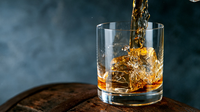 Pouring orange alcohol into a glass