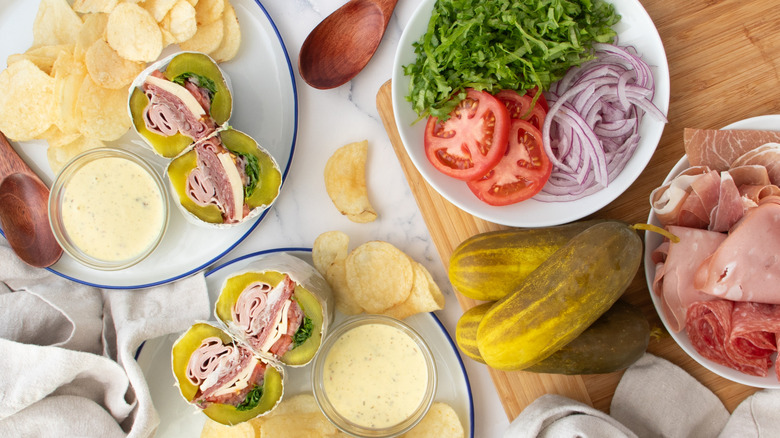 sandwiches with pickles, vegetables, and potato chips