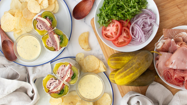 sandwiches with pickles, vegetables, and potato chips