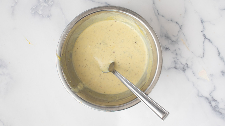 creamy yellowish sauce in a metal bowl