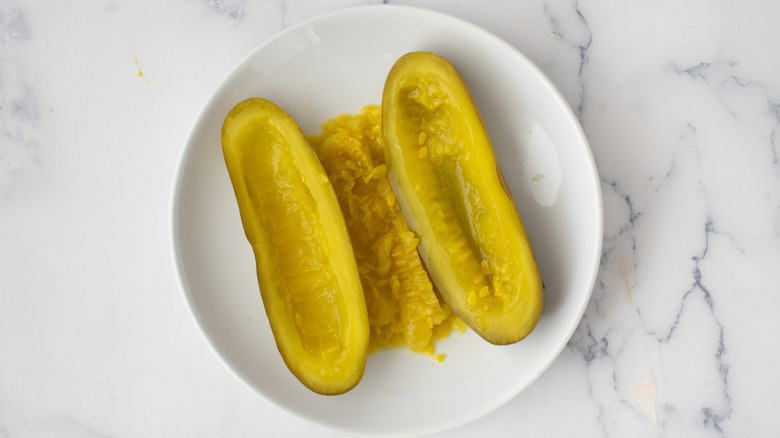 large pickle halves on a white plate