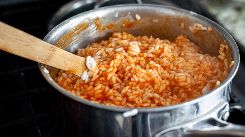 rice and sauce being mixed