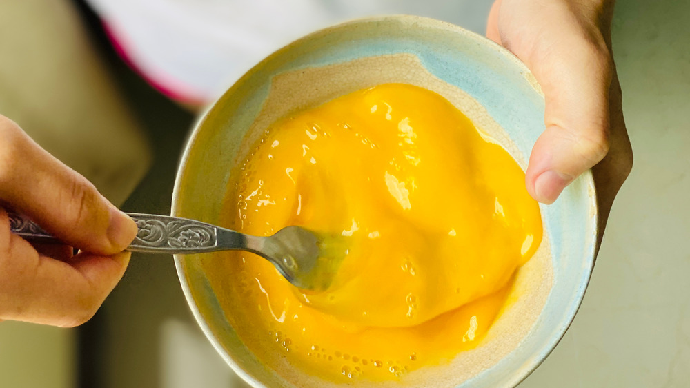 Whisking eggs in a bowl with a fork