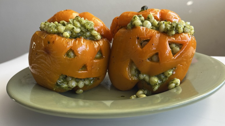 two stuffed jack-o-lantern peppers